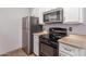 Updated kitchen features modern stainless steel appliances, granite countertops, and white cabinetry at 3500 N Hayden Rd # 801, Scottsdale, AZ 85251