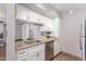 Well-lit kitchen features stainless steel appliances, granite countertops, and white cabinets at 3500 N Hayden Rd # 801, Scottsdale, AZ 85251