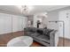 Cozy living room with a tufted sofa, sleek lighting, and access to the kitchen and dining areas at 3500 N Hayden Rd # 801, Scottsdale, AZ 85251