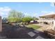 Backyard with desert landscaping, covered patio and storage shed at 3508 E Gelding Dr, Phoenix, AZ 85032
