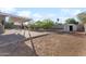 Expansive backyard featuring a covered patio and a storage shed at 3508 E Gelding Dr, Phoenix, AZ 85032