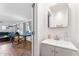 Well-lit bathroom with a modern vanity and a view into the living room at 3508 E Gelding Dr, Phoenix, AZ 85032