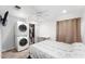 Comfortable bedroom with laundry machines, closet, ceiling fan, and natural light at 3508 E Gelding Dr, Phoenix, AZ 85032