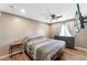 Bedroom with ceiling fan, window, and gray dresser at 3508 E Gelding Dr, Phoenix, AZ 85032