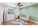 Cozy Bedroom with a wooden crib, teepee, ceiling fan, and natural light at 3508 E Gelding Dr, Phoenix, AZ 85032