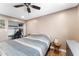 Neutral bedroom with a ceiling fan, closet, and bedside table at 3508 E Gelding Dr, Phoenix, AZ 85032