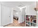 Bright hallway with access to multiple rooms and a built-in bookshelf at 3508 E Gelding Dr, Phoenix, AZ 85032