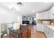 Open floor plan with modern kitchen and view to the living room and comfortable seating area at 3508 E Gelding Dr, Phoenix, AZ 85032