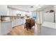 Well-lit kitchen with white cabinets, an island, and a sliding glass door leading to the backyard at 3508 E Gelding Dr, Phoenix, AZ 85032