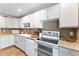 Kitchen with white appliances and cabinetry, complete with modern oven and tile backsplash at 3508 E Gelding Dr, Phoenix, AZ 85032