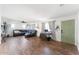 Spacious living room with stylish wood floors, a modern ceiling fan, and a comfortable leather sectional at 3508 E Gelding Dr, Phoenix, AZ 85032
