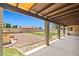Beautifully landscaped backyard with a covered patio, gravel area, and well-maintained lawn at 3747 W Aire Libre Ave, Phoenix, AZ 85053