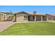 Beautiful home with a green backyard, gravel landscaping, and a covered parking area at 3747 W Aire Libre Ave, Phoenix, AZ 85053