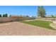 Expansive backyard with gravel accents, artificial turf, and a secure block wall for privacy at 3747 W Aire Libre Ave, Phoenix, AZ 85053