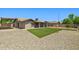 Large backyard with green turf, gravel, and a covered patio perfect for outdoor living at 3747 W Aire Libre Ave, Phoenix, AZ 85053