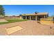 Well-maintained backyard featuring artificial turf, gravel areas, and a private hot tub setup at 3747 W Aire Libre Ave, Phoenix, AZ 85053