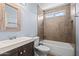 Neutral bathroom with a tiled shower and bathtub combo, vanity sink, and fixtures at 3747 W Aire Libre Ave, Phoenix, AZ 85053