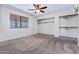 Neutral carpeted bedroom featuring a closet and a window with blinds at 3747 W Aire Libre Ave, Phoenix, AZ 85053
