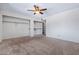 Carpeted bedroom with an open closet featuring shelves and hanging rods at 3747 W Aire Libre Ave, Phoenix, AZ 85053