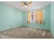 Bedroom boasts soft carpet and natural light through a window with neutral curtains at 3747 W Aire Libre Ave, Phoenix, AZ 85053