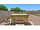 Relaxing hot tub area surrounded by gravel and lush greenery in the backyard at 3747 W Aire Libre Ave, Phoenix, AZ 85053