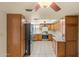 Charming kitchen with wood cabinets, tile flooring, and stainless steel appliances at 3747 W Aire Libre Ave, Phoenix, AZ 85053