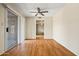 Bright living room features wood floors, ceiling fan and sliding glass door access to the outside at 3747 W Aire Libre Ave, Phoenix, AZ 85053