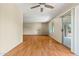 Well-lit living room boasts wood floors, ceiling fan, and sliding glass door to the outside at 3747 W Aire Libre Ave, Phoenix, AZ 85053