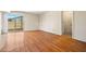 Bright living room features wood floors and sliding glass door access to the outdoor patio at 3747 W Aire Libre Ave, Phoenix, AZ 85053