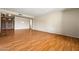 Spacious living room with hardwood floors and a large window offering plenty of natural light at 3747 W Aire Libre Ave, Phoenix, AZ 85053