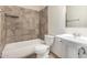 Cozy bathroom featuring tiled shower-tub, pedestal sink and toilet with tiled flooring at 3821 N 28Th St, Phoenix, AZ 85016