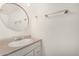 Clean bathroom with a round mirror, neutral vanity and a shower with tiled walls at 3821 N 28Th St, Phoenix, AZ 85016