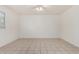 Empty bedroom with a ceiling fan, window, and neutral colored tile floors at 3821 N 28Th St, Phoenix, AZ 85016