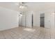 Spacious bedroom with neutral paint, tile flooring, ceiling fan and access to bathrooms at 3821 N 28Th St, Phoenix, AZ 85016