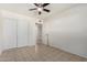 A bedroom with a ceiling fan, tile flooring, closet, and an open door that leads to the bathroom at 3821 N 28Th St, Phoenix, AZ 85016