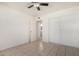 This bedroom features a ceiling fan, tile flooring, and easy access to an adjoining bathroom at 3821 N 28Th St, Phoenix, AZ 85016