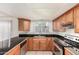 Bright kitchen featuring light wood cabinets, black countertops and stainless steel appliances at 3821 N 28Th St, Phoenix, AZ 85016