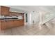 Bright and open kitchen with tiled floors, wood cabinets, and a staircase nearby at 3821 N 28Th St, Phoenix, AZ 85016