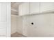 Laundry room with white shelving and cabinets for storing supplies and essentials at 3821 N 28Th St, Phoenix, AZ 85016
