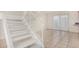 Bright living room with tiled floors, staircase, and sliding door access to the outside at 3821 N 28Th St, Phoenix, AZ 85016