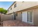 Outdoor patio area with red brick flooring, a fence, and a sliding door to the house at 3821 N 28Th St, Phoenix, AZ 85016