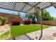 Lush backyard featuring artificial turf, mature trees and landscaping at 3829 W Camino Del Rio --, Glendale, AZ 85310