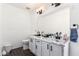 This bathroom offers dual sinks, dark hardware and wood look flooring at 3829 W Camino Del Rio --, Glendale, AZ 85310