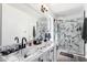 This bathroom offers dual sinks, a decorative accent wall and a frameless shower at 3829 W Camino Del Rio --, Glendale, AZ 85310