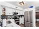 This modern kitchen features white cabinets, stainless steel appliances, and a stone tile backsplash at 3829 W Camino Del Rio --, Glendale, AZ 85310