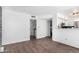Bright, open-concept living area with wood floors and laundry room in the background at 3829 W Camino Del Rio --, Glendale, AZ 85310