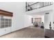 Bright living room boasting a lofted ceiling, large windows, and sleek wood laminate flooring at 3829 W Camino Del Rio --, Glendale, AZ 85310