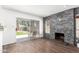 Cozy living room with stone accent wall, fireplace, and sliding glass door with backyard access at 3829 W Camino Del Rio --, Glendale, AZ 85310