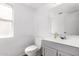 This powder room features a gray vanity and natural light from the window at 3829 W Camino Del Rio --, Glendale, AZ 85310