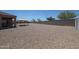 Expansive backyard covered with gravel, a covered patio, and a gazebo at 4088 N 309Th Cir, Buckeye, AZ 85396